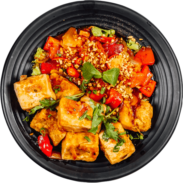 A black dish consisting chicken and hot pepper